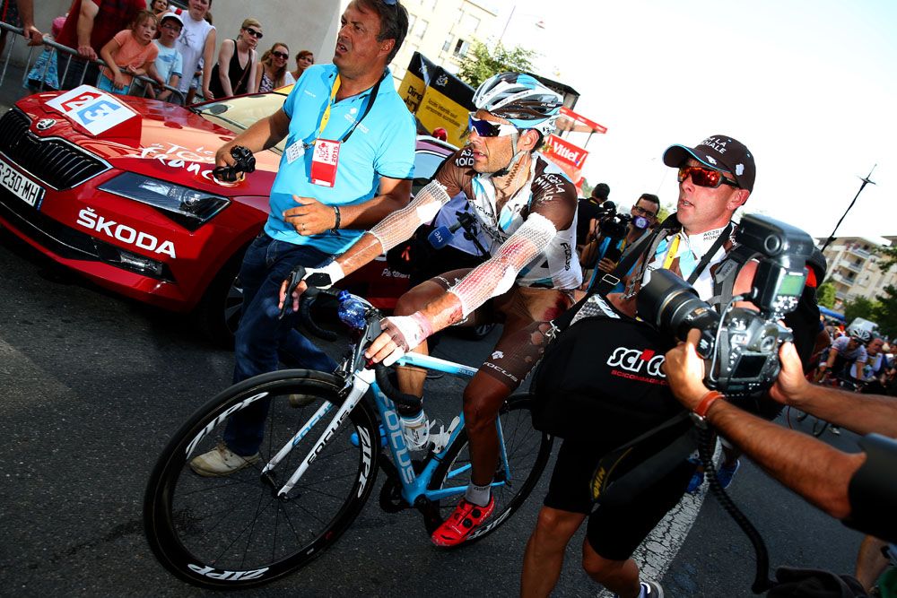 A battered Jean Christophe Peraud crosses the line