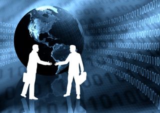 silhouettes of two people shaking hands in front of blue world globe with binary code in the background