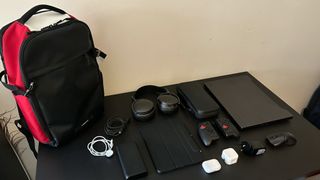 Timbuk2 Division backpack with range of tech and accessories laid out on a table