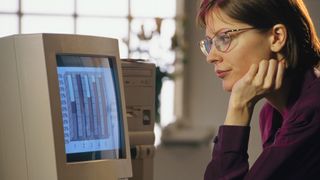 A woman using a 1990s desktop PC