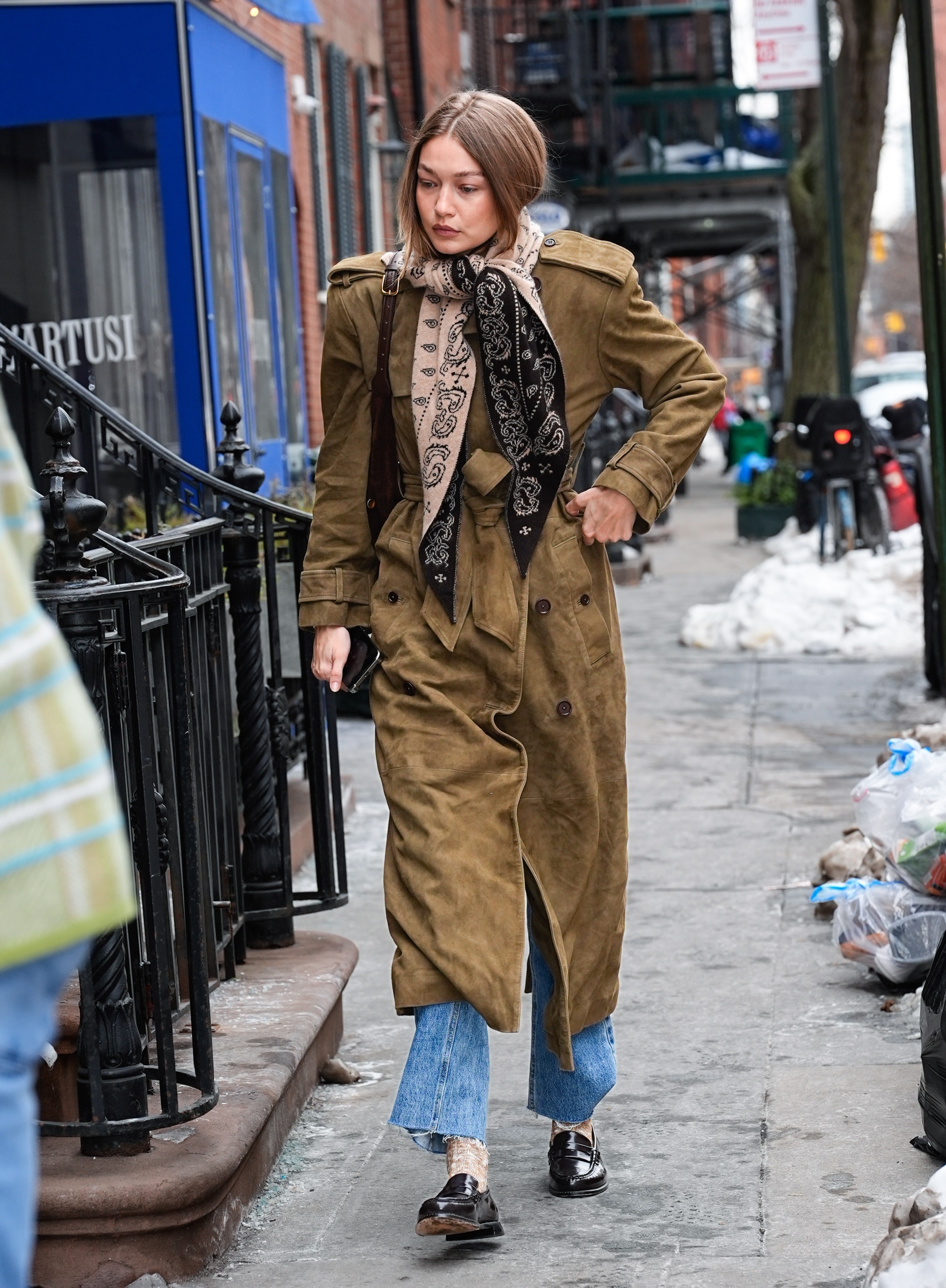 Gigi Hadid wears a suede trench coat from Helsa whilst out in New York.