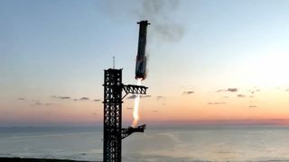 SpaceX's Starship Flight 5 Super Heavy booster approaches its launch tower for the first-ever landing and capture at the pad after launching on a suborbital test flight from Starbase in South Texas on Oct. 13, 2024.