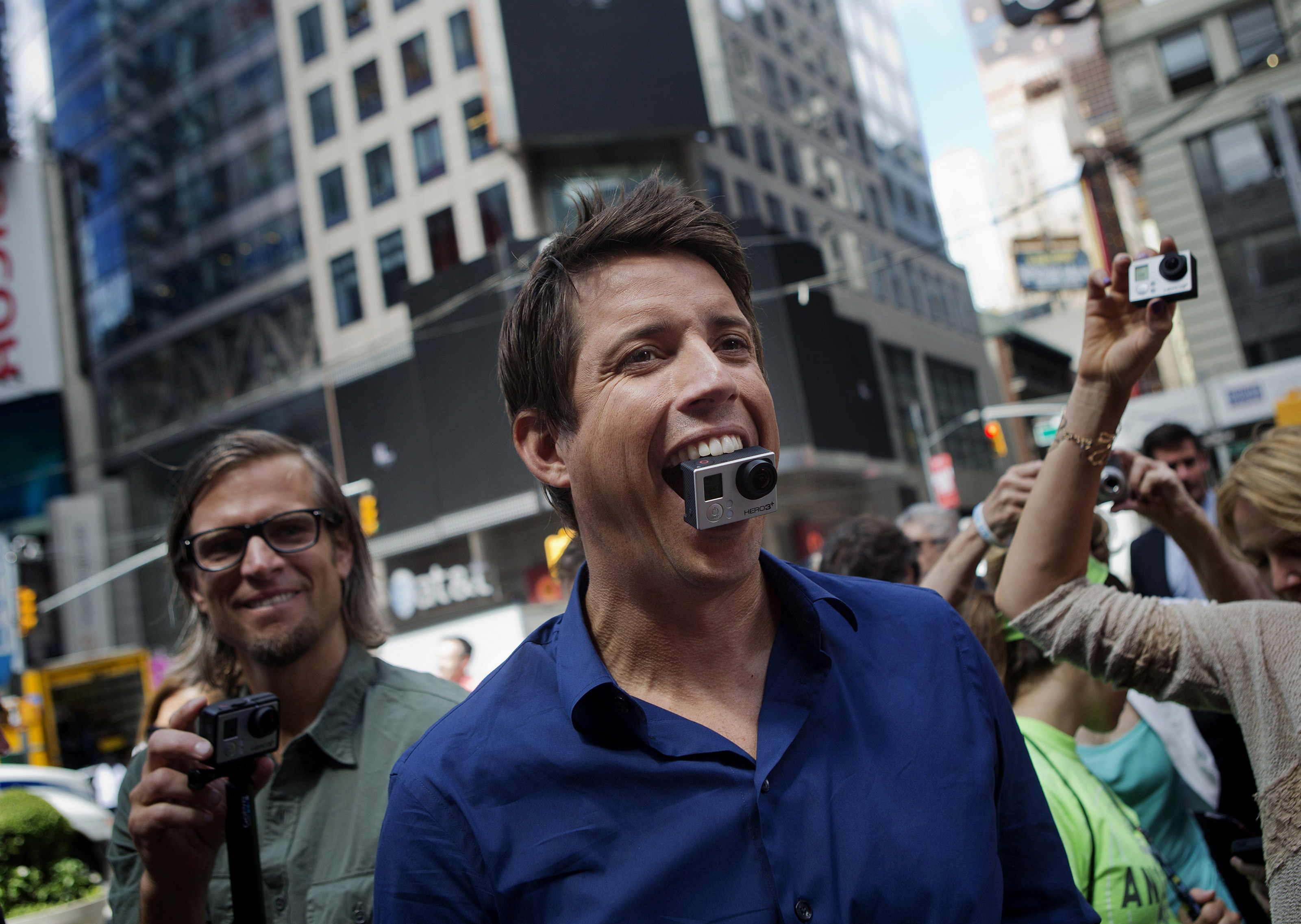 Bloomberg's Best Photos 2014: Nick Woodman, founder and chief executive officer of GoPro Inc., stands for a photograph with a GoPro Hero 3+ camera in his mouth after ringing the opening bell for the release of the company's IPO at the Nasdaq MarketSite in New York, U.S., on Thursday, June 26, 2014