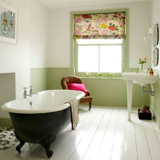 bathroom with white and grey bathtub and white wooden flooring