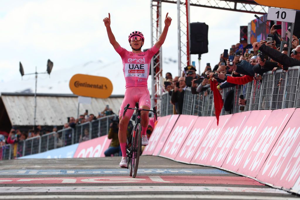 Pink jersey Team UAE's Slovenian rider Tadej Pogacar celebrates as he crosses the finish line to win the 15th stage of the 107th Giro d'Italia cycling race, 222km between Manerba del Garda and Mottolino on May 19, 2024. (Photo by Luca Bettini / AFP)