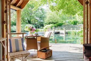 View over a lake from a summerhouse veranda with decking area