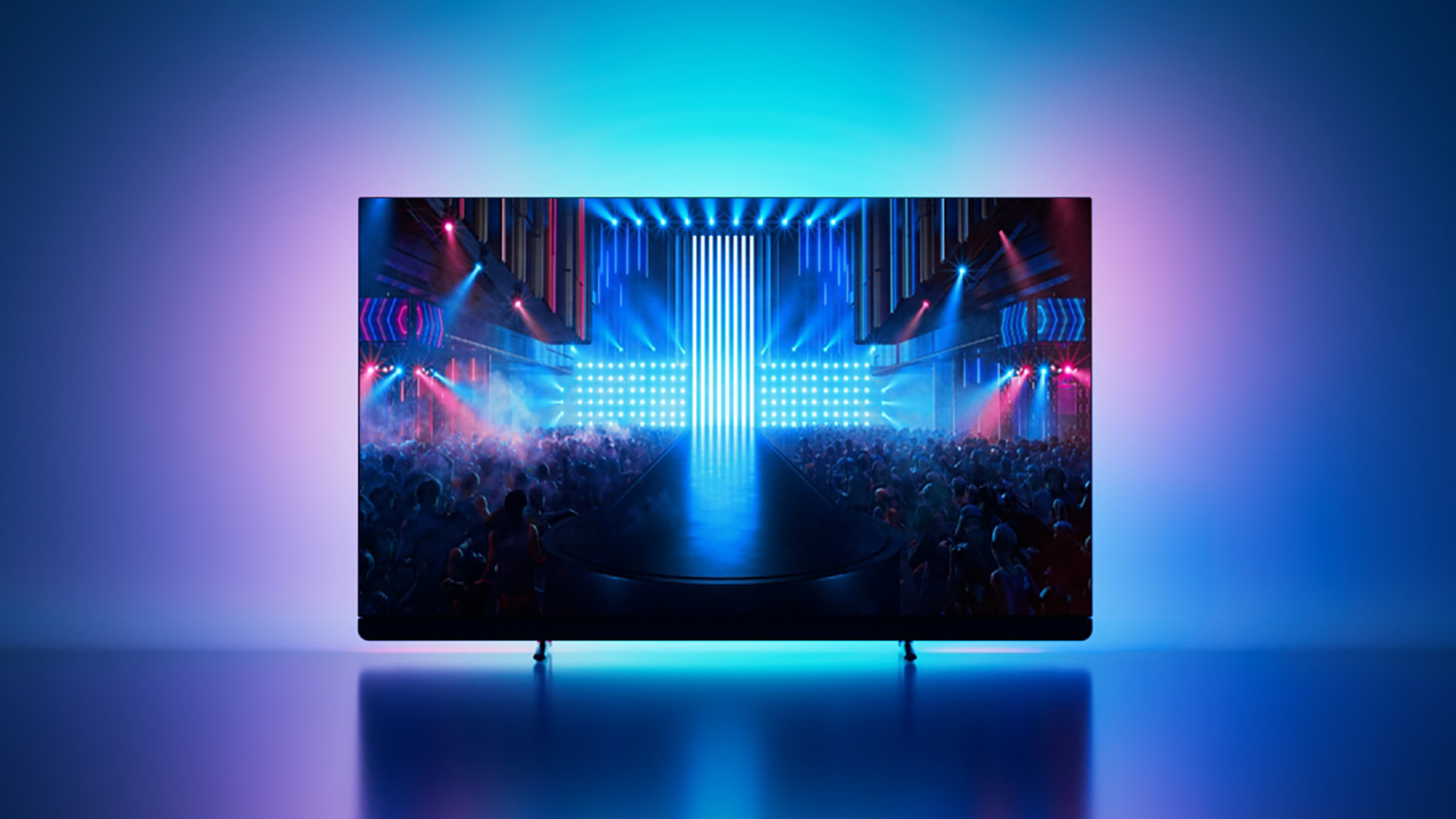 Philips OLED 909 with Ambilight shining on the wall behind in blue and pink