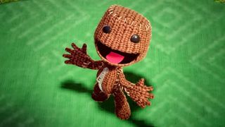 Sackboy sticking his tongue art and waving his hands up in the air
