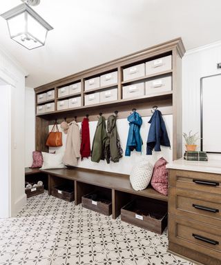 mudroom with built in storage made from wood and drawers with patterned flooring - Neat Little Nest