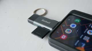 Beikell USB memory card reader adapter connected to smartphone.