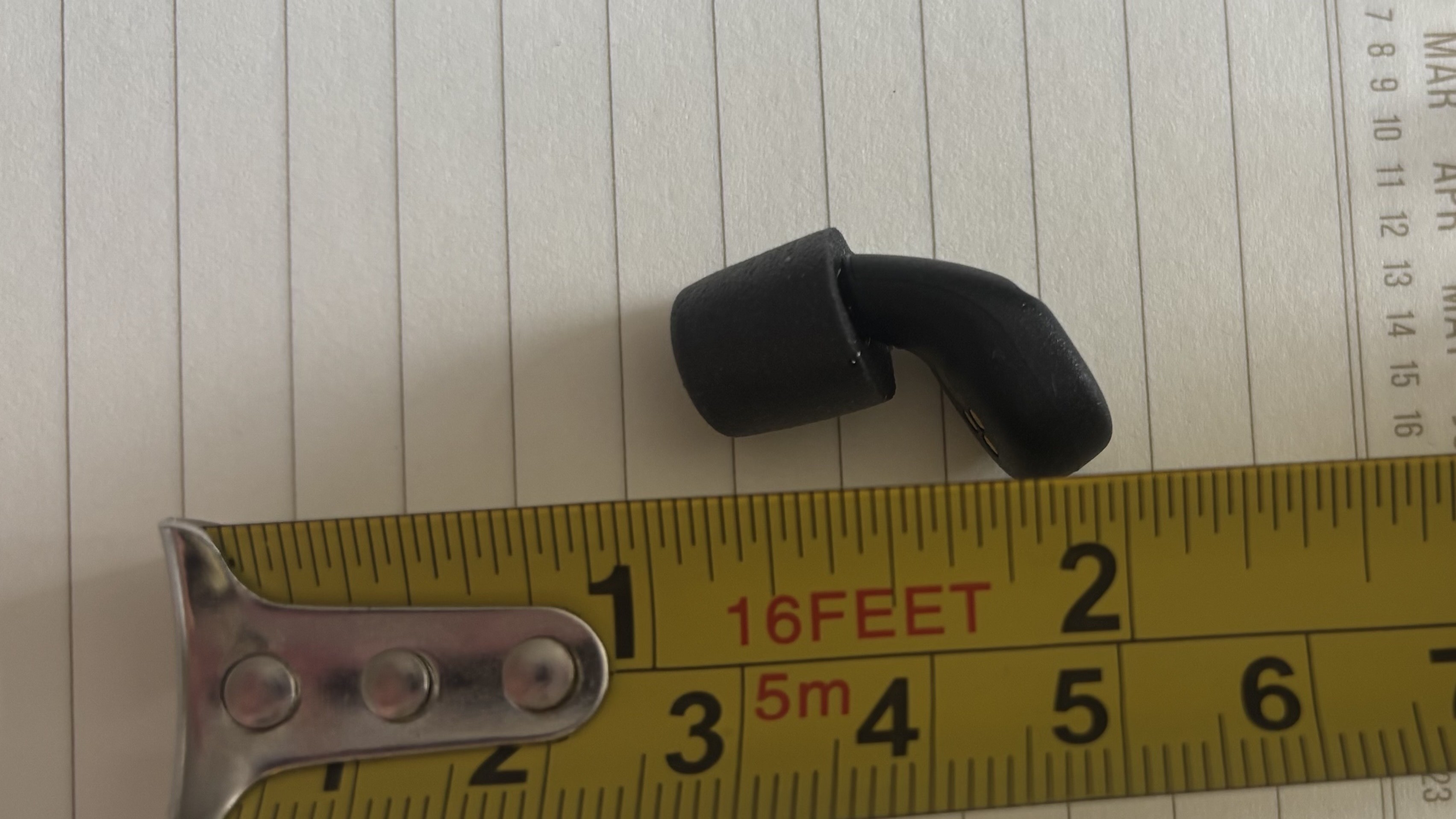 A ruler measuring the lenght of the QuietOn 4. 