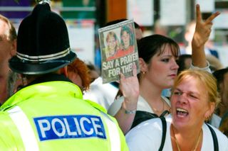 Protestors holding a picture of murdered schoolgirls Holly Wells and Jessica Chapman