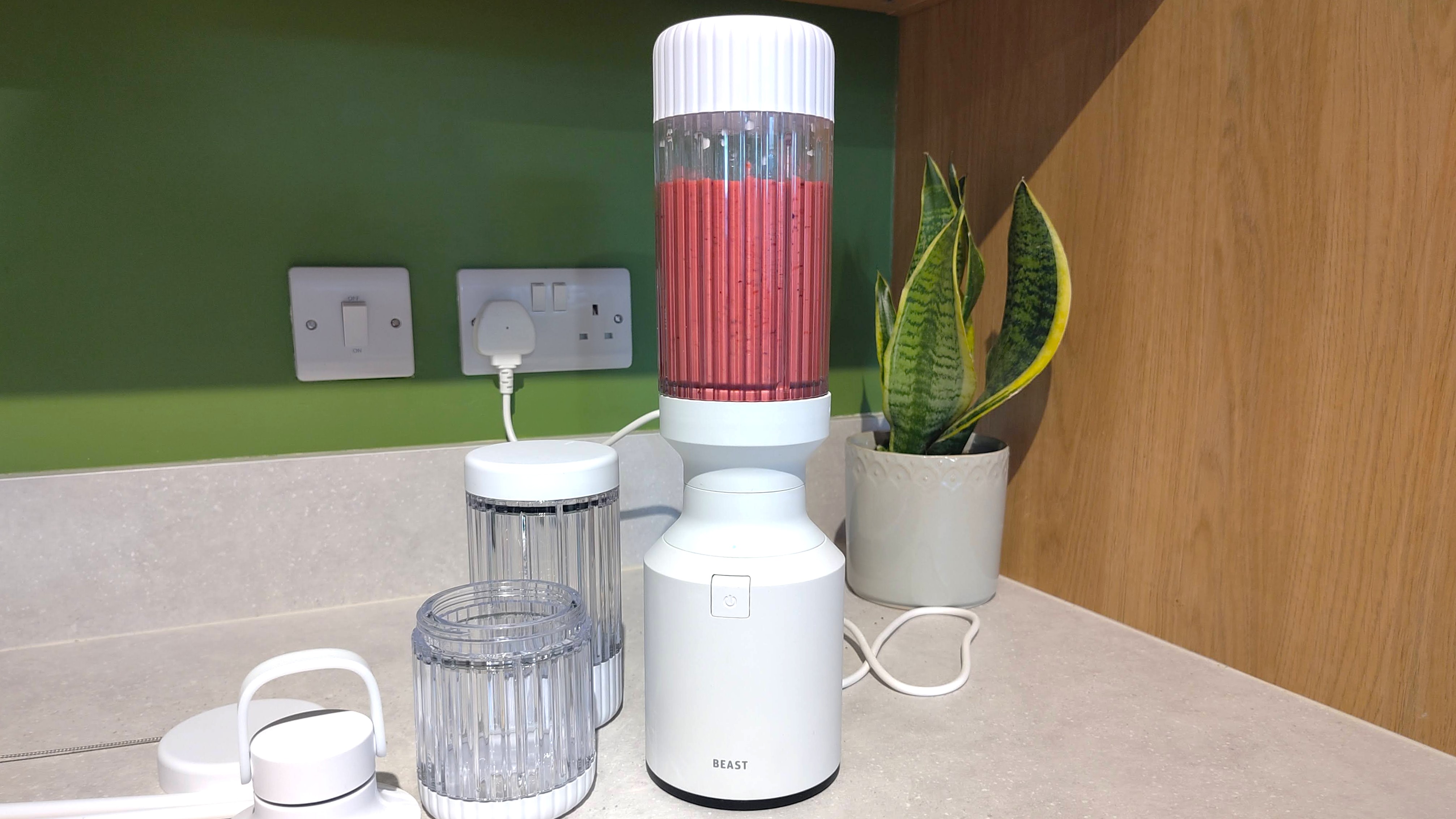 Beast Mighty 850 Plus blender containing mixed berry smoothie