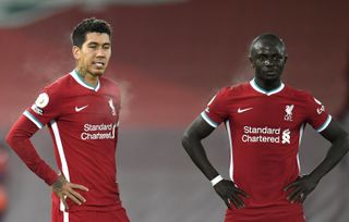 Roberto Firmino and Sadio Mane stand with their hands on their hips