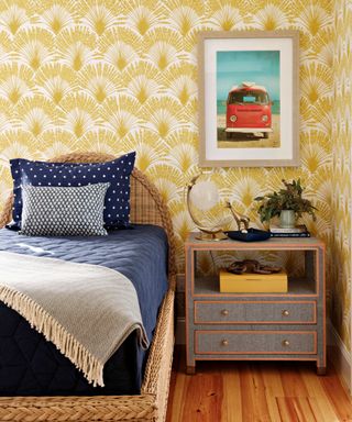 Kids bedroom with yellow wallpaper and blue bedding