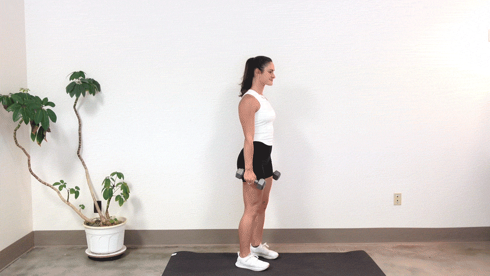 trainer Kirra Mitlo doing a dumbbell deadlift curl to press