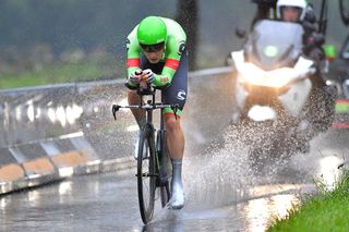 Dylan van Baarle kicking up some serious spray on the drenched roads