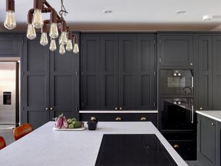 kitchen with dark kitchen units and white island by Higham Furniture