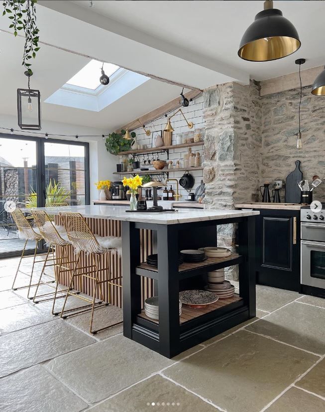 A kitchen with bifold doors in the background