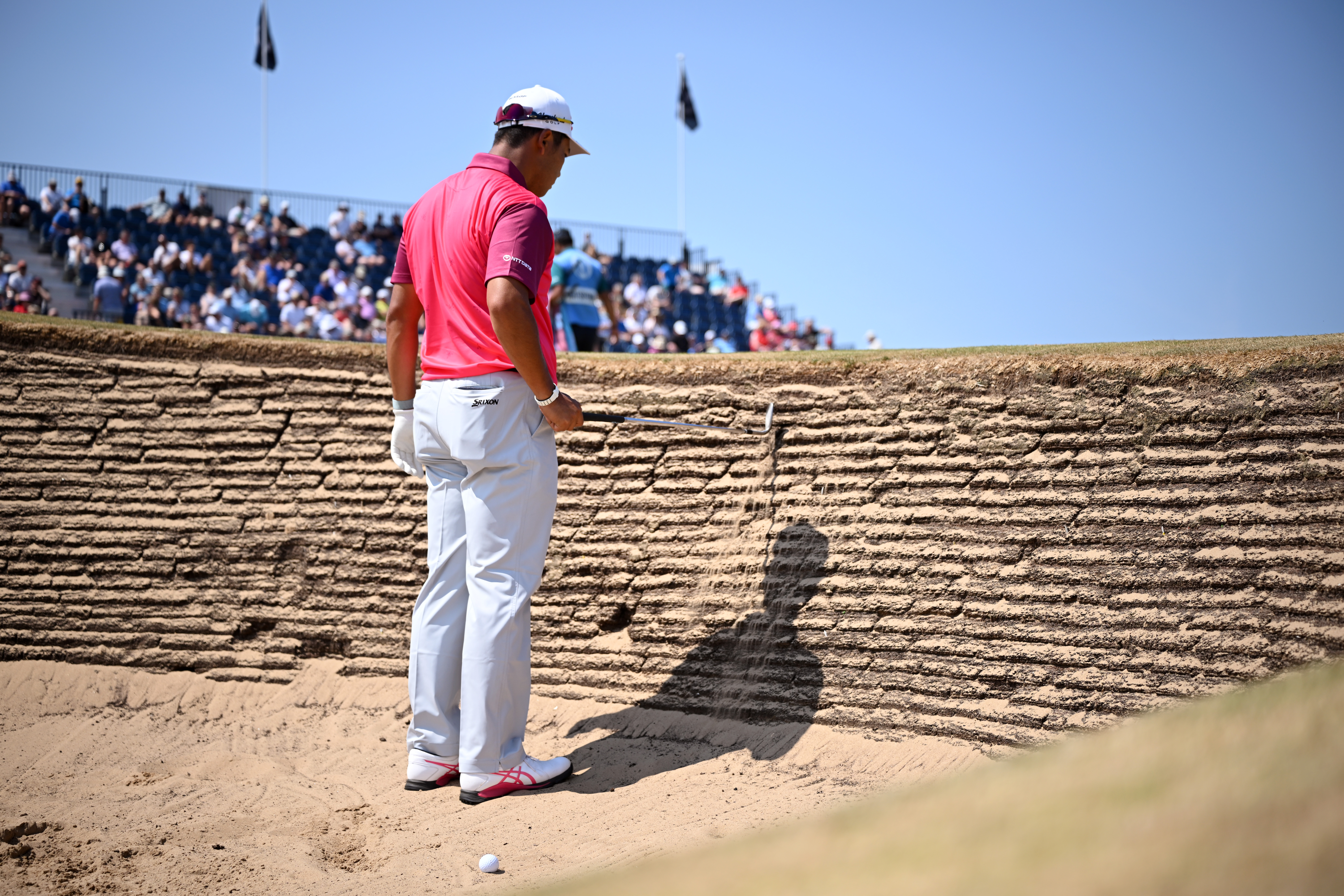 Hideki Matsuyama stands inside a revetted bunker at Royal Birkdale during a practice round ahead of The Open in 2026