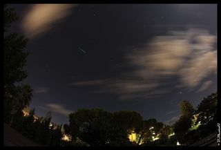 A draconid streaks over Palermo, Italy in 2011.