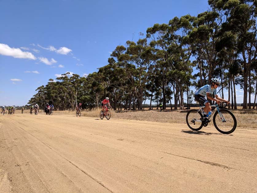 The road breaks up slightly as the riders pass through