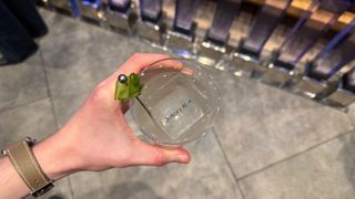 A cocktail glass with an ice cube that says Galaxy Ai on it