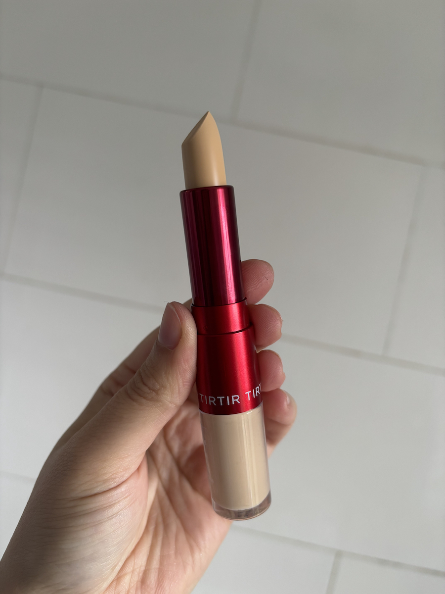 Mica Ricketts holding TirTir Glide & Hide Blurring Concealer