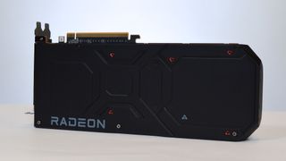 An AMD Radeon RX 7900 XTX on a table against a white backdrop