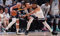 Aaron Gordon #50 of the Denver Nuggets handles the ball while Karl-Anthony Towns #32 of the Minnesota Timberwolves plays defense during the game during Round 2 Game 4 of the 2024 NBA Playoffs on May 12, 2024 at Target Center in Minneapolis, Minnesota. 
