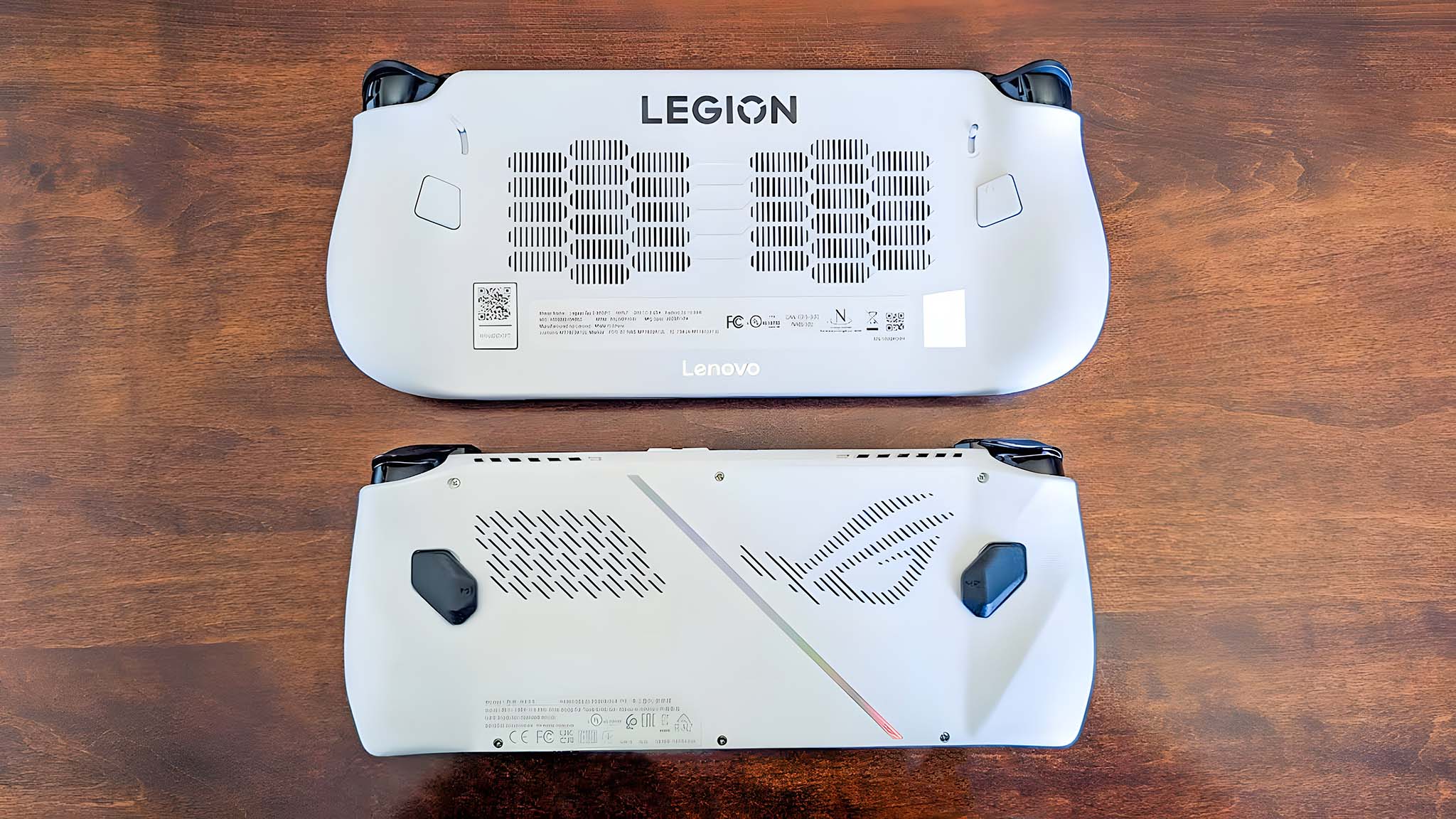 Back sides of the Lenovo Legion Go S and ROG Ally.