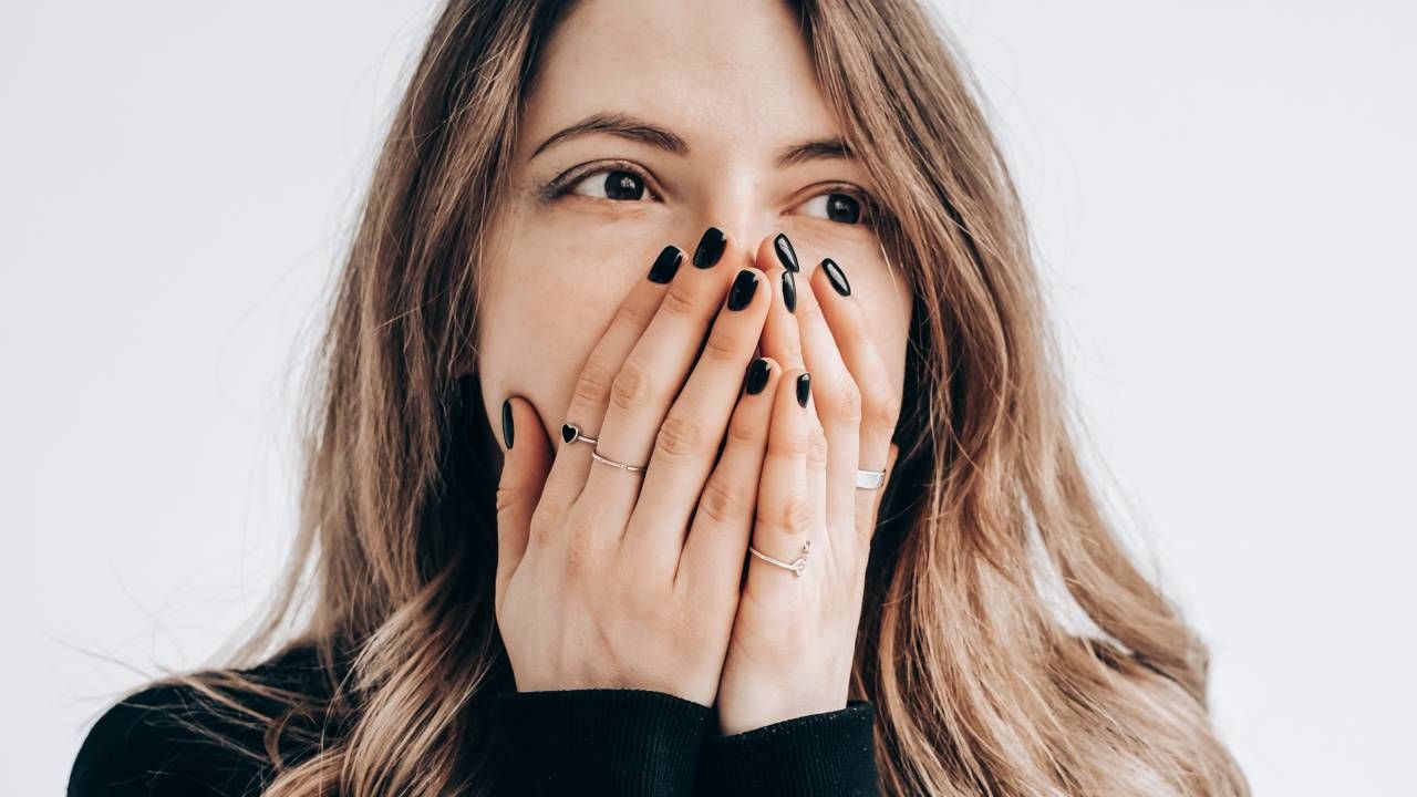 Mouth taping sleep hack, woman covering her mouth with both hands