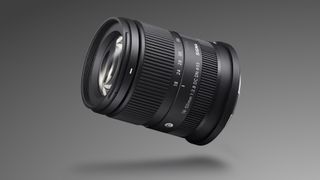 Sigma 18-50mm f/2.8 DC DN | C Canon RF lens against a grey, gradient background