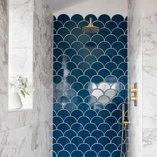 shower with brassware and marble wall