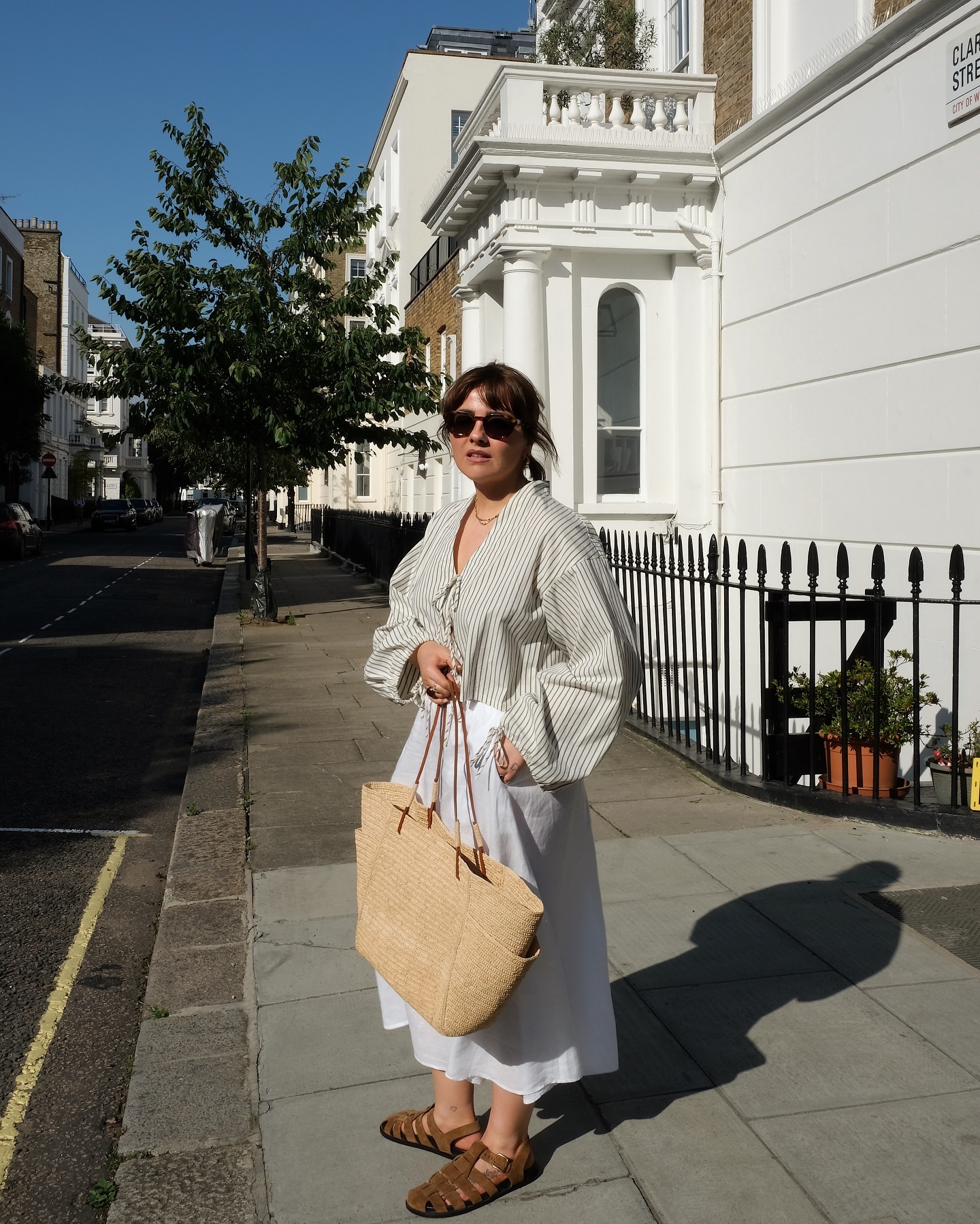 Influencer wears suede fisherman sandals.