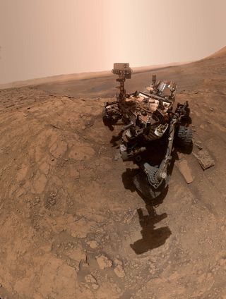 NASA's Curiosity rover, which has been exploring Mars for the last 7 years, took a new selfie on the Red Planet this month. The image is a panorama combining 57 images taken by the Mars Hand Lens Imager (MAHLI), a camera on the end of the rover's robotic arm, and the rover's arm isn't visible in all of the frame that make up the composite. When Curiosity made this selfie on Oct. 11, it was exploring an area called "Glen Ative" inside Gale Crater, where it recently drilled two holes that are visible on the left.