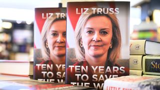 Two propped-up copies of Liz Truss's book "Ten Years to Save the World" in a bookshop, 16 April 2024