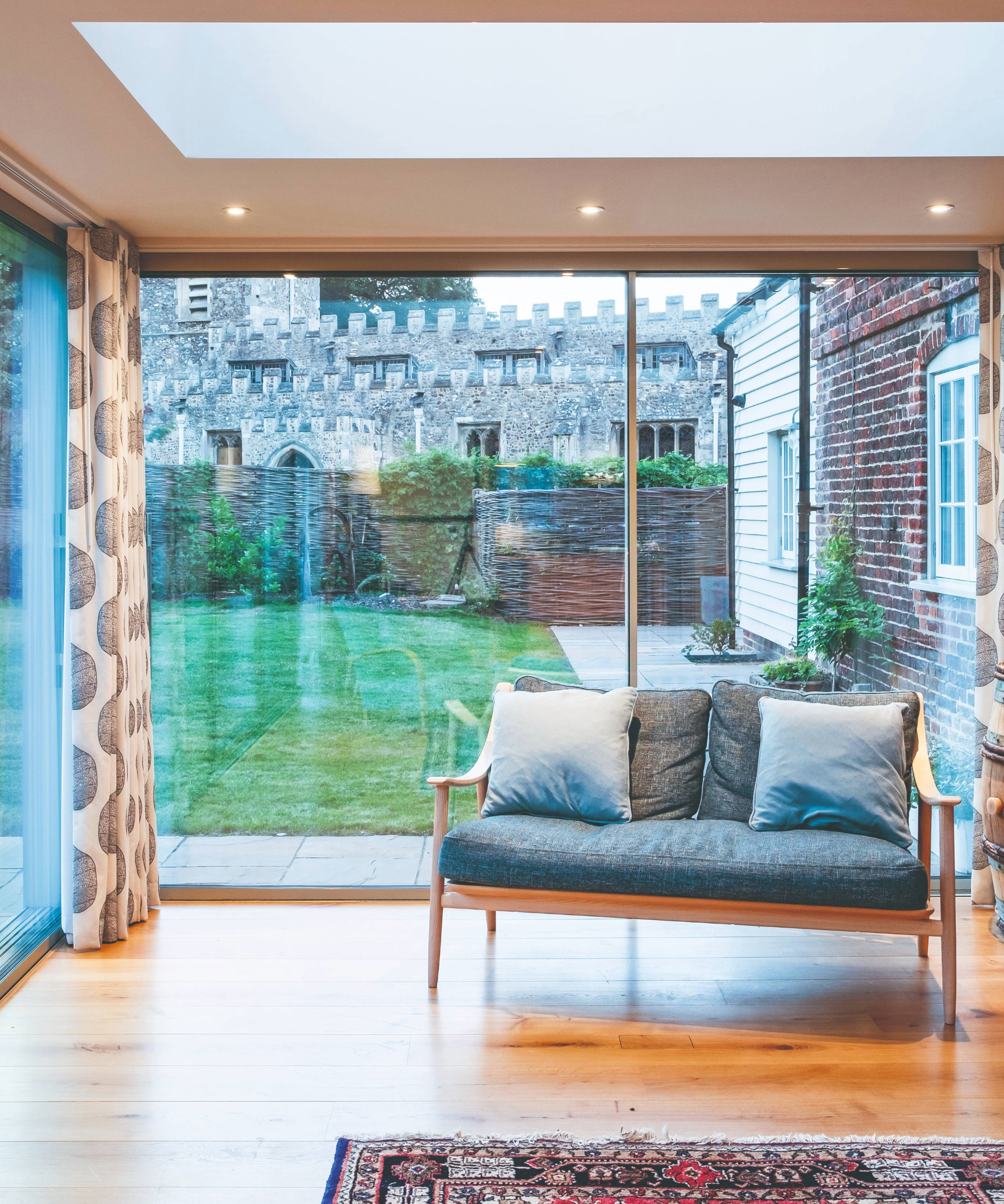 Box extension living room with floor to ceiling windows overlooking the church
