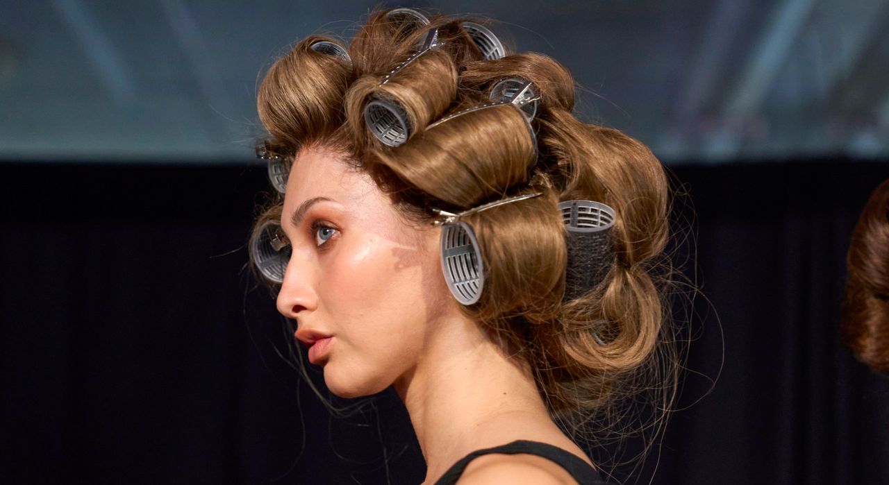 A model with curlers backstage at Serio Hudson 