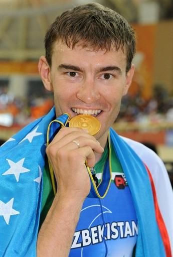 Points race winner Vladimir Tuychiev (Uzbekistan) takes a bite of his gold medal.