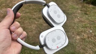 Nothing Headphones (1) in white held in the hand