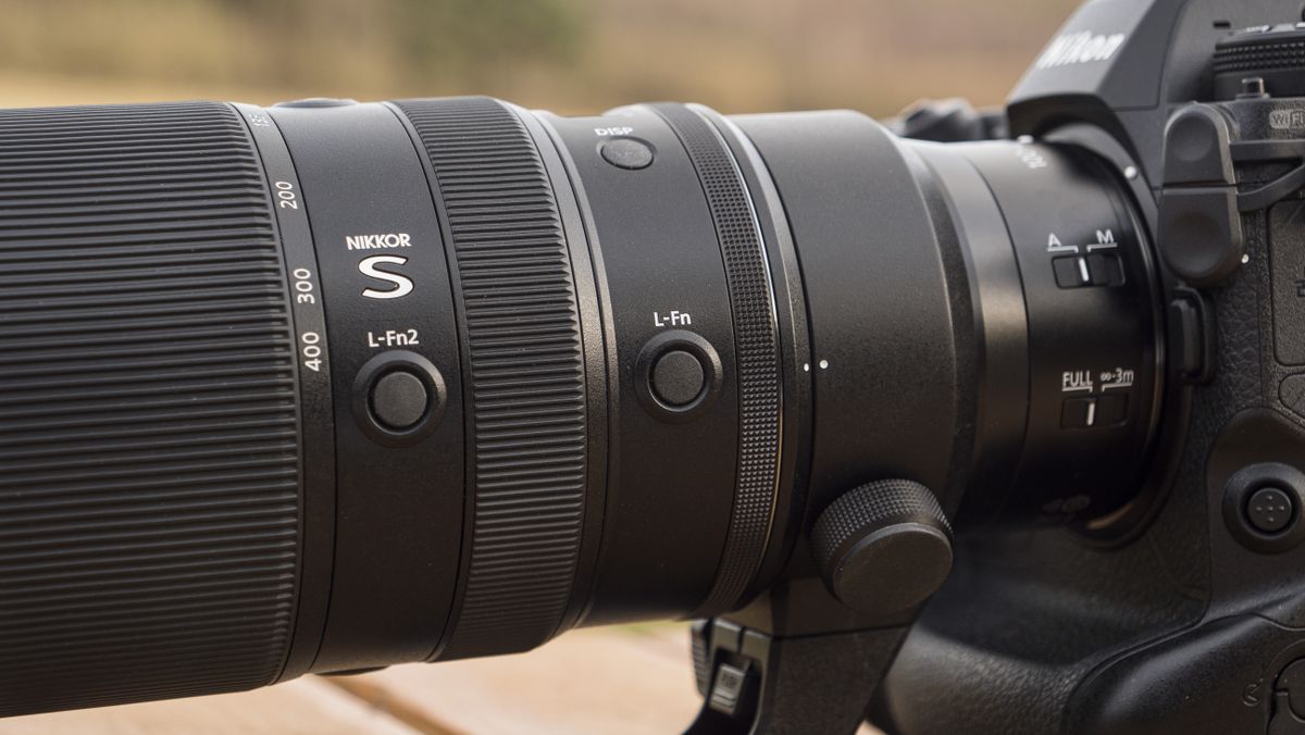 A Nikon Z telephoto lens on a wooden table