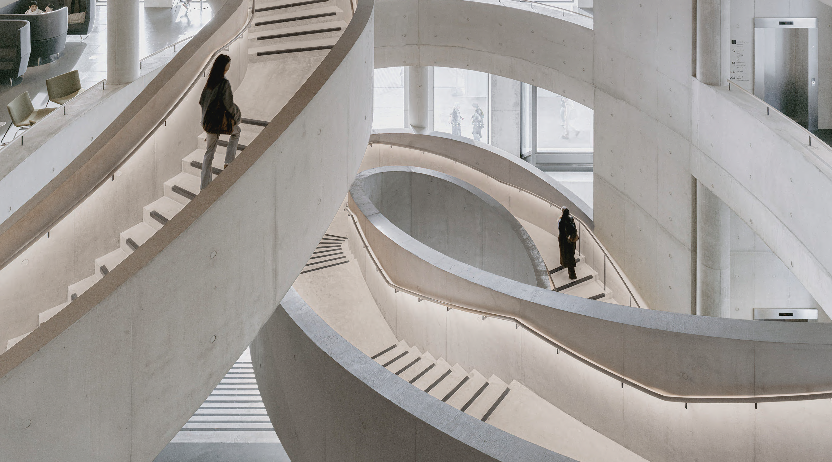 Inside a building with sweeping white curving staircases