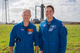 NASA astronauts Doug Hurley (left) and Bob Behnken, who will fly to the International Space Station on SpaceX’s Demo-2 mission, stand near Launch Pad 39A at the NASA’s Kennedy Space Center in Florida on Jan. 17, 2020.