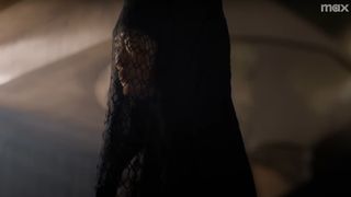 A sister of the Bene Gesserit in Dune: Prophecy. Close up of an adult woman wearing a black veil and dress.