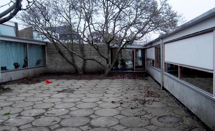 Circular paved courtyard surrounded by classrooms and corridors.