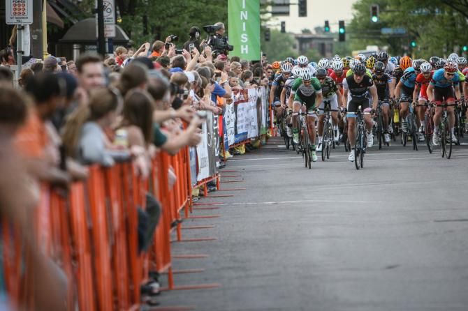 The men leave the start line in front of thick crowds.
