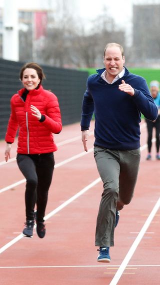 Prince William and Kate Middleton racing on a running track