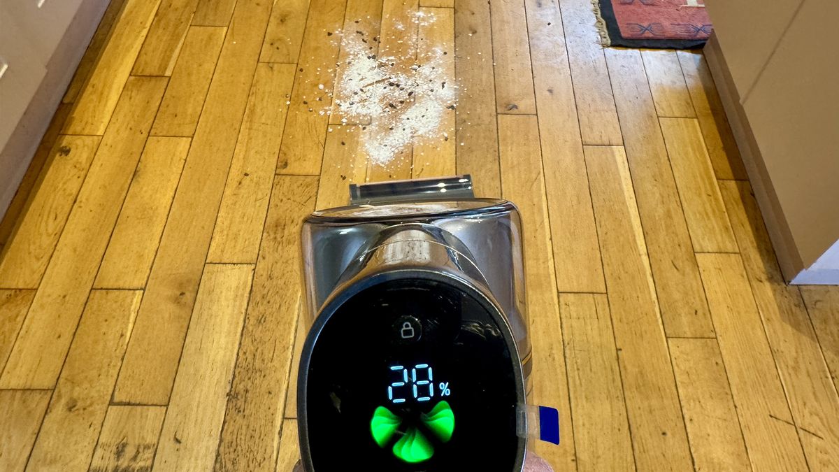 Dreame R20 cordless vacuum preparing to clean a mixture of flour, oats and cereal from a hard floor