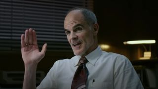 Michael Kelly gestures with his hand in conversation in Transformers: Rise of the Beasts.